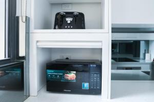a microwave oven sitting inside of a building at Central CBD High-Level Apartment with Views in Sydney