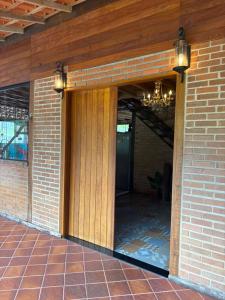 a front door of a brick house with a chandelier at Casa da Cuca in Nova Friburgo