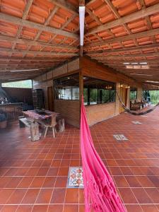 an outdoor patio with a hammock in a house at Casa da Cuca in Nova Friburgo