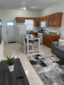 a kitchen and living room with a table and a couch at Sea View Escape in The Valley