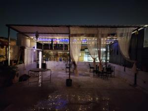 a patio with a table and chairs at night at Hathai in Jodhpur