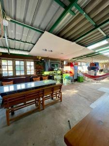 a large room with a ping pong table in it at Lee Red House Homestay in Ban Ao Yai