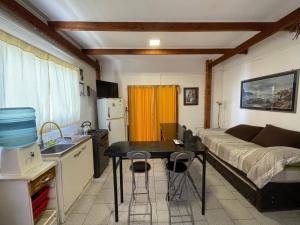 a kitchen with a bed and a table in a room at Hostal Mar De Bahía in Bahia Inglesa