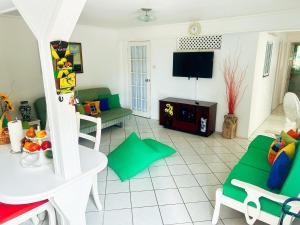 a living room with a couch and a table at Krystal Apartment in Grande Rivière
