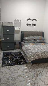 a bedroom with a bed and a dresser at MiniHaus2Stay in Pulau Sebang
