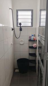 a bathroom with a black toilet in a room at MiniHaus2Stay in Pulau Sebang
