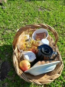 a basket filled with food and bread on the grass at cabana Eco da Natureza in Praia Grande