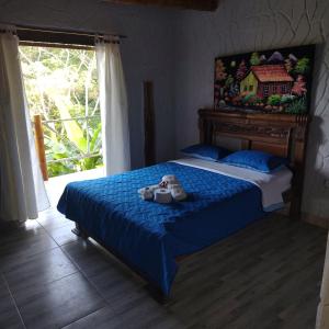 En eller flere senge i et værelse på Hotel El Santuario