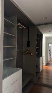 a room with a closet with white shelves at Casa DOURO-PORTO in Valbom