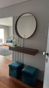 a mirror and two blue stools in a living room at Casa DOURO-PORTO in Valbom +17 photos
