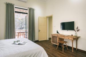 Et tv og/eller underholdning på Indochine Gloria Home by Silk Path