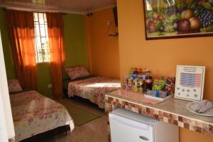 a room with two beds and a counter with snacks at habitacion doble 1 Marcia place in San Andrés