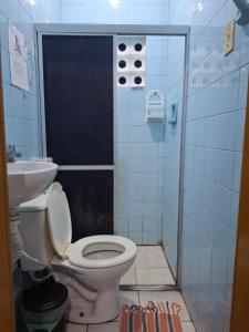 a bathroom with a toilet and a sink at Pousada UFPE INN in Recife +94 photos