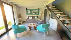 a living room with a bed and a staircase at Complejo Los Saucos II in El Hoyo