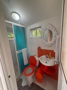 a bathroom with a red toilet and a sink at double room # 2 in San Andrés