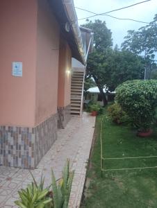 a house with a brick walkway next to a building at double room # 2 in San Andrés