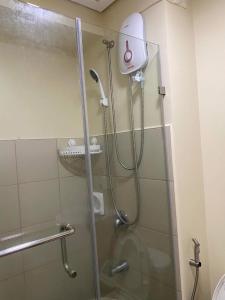 a shower with a glass door in a bathroom at Avida Tower 2 in Davao City +9 photos