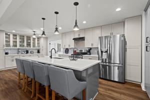 a kitchen with a large island with chairs and a refrigerator at Chic & Comfy Stay Close to Everything in Marietta