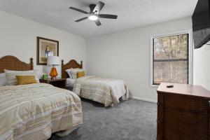 a bedroom with two beds and a ceiling fan at Chic & Comfy Stay Close to Everything in Marietta