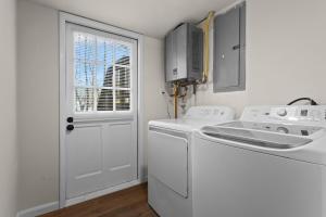a white laundry room with a washer and dryer at Chic & Comfy Stay Close to Everything in Marietta +34 photos