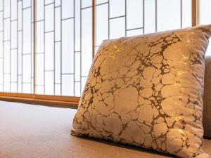 a pillow sitting on the floor next to a window at AKEKURE Kyoto Shirakawa in Kyoto