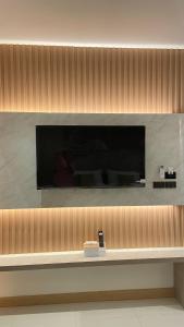a television on a wall in a room at Mermayda pool villa hatyai -เมอเมดา in Hat Yai