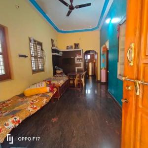 a room with two beds and a table in it at M R ViLLA HAMPI magic rock villa in Hampi +11 photos