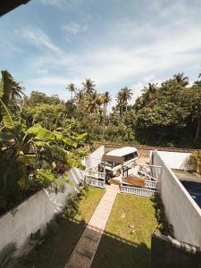 a view of a garden with chairs and a pool at Nirvana Surf Retreat - Kabalana in Atadahewatugoda