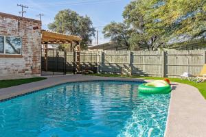 a swimming pool with a toy boat in a yard at Charming 3BR Midtown Home w Pool in Tucson