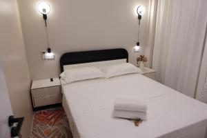 a bedroom with a large white bed with two pillows at Nadi Ease Stay Near McDonalds in Nadi