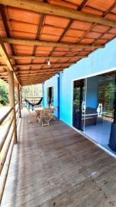 a wooden deck with a hammock on a house at Paraíso Azul in Ilhéus +4 photos