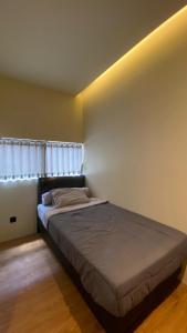a bedroom with a bed in a room at First Kost Seturan 32 in Yogyakarta