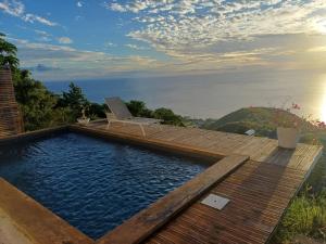 a lap pool with a laptop on a wooden deck at Kevio in Chambort
