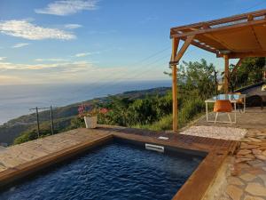 a swimming pool with a view of the ocean at Kevio in Chambort
