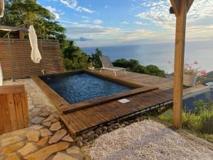 a swimming pool with a table and a chair on a deck at Kevio in Chambort