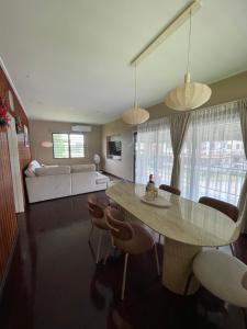 a living room with a table and chairs and a couch at Villa Japandi in Paramaribo