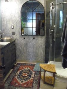 a bathroom with a shower and a rug at Riverhouse Hidden Gem in The Dalles
