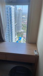 a window in a room with a view of a city at ANDERSON BENSON CONNECT PAKUWON MAll in Surabaya