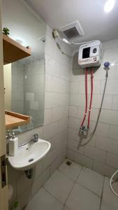 a bathroom with a shower and a sink at ANDERSON BENSON CONNECT PAKUWON MAll in Surabaya