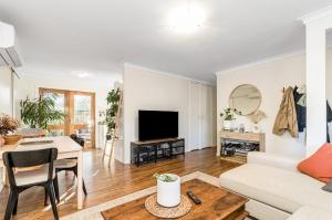 a living room with a couch and a table at The Unit Lennox Head in Lennox Head