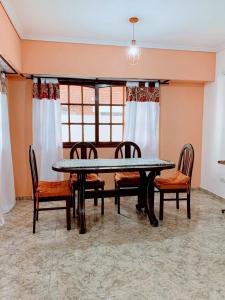 a dining room with a table and four chairs at Piso entero La Boca in Buenos Aires