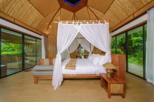 a bedroom with a canopy bed in a room with windows at Aonang Fiore Resort in Ao Nang Beach +84 photos