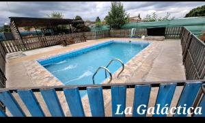 a swimming pool with a blue fence around it at La Galactica in Salta