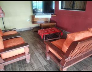 a room with several wooden chairs and a piano at La Galactica in Salta