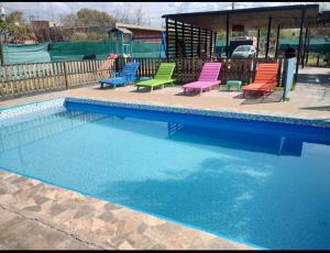 a group of chairs sitting next to a swimming pool at La Galactica in Salta