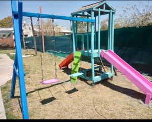 a playground with a slide and a swing at La Galactica in Salta