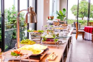 a buffet line with many different types of food at Dragon Sea Sam Son Hotel in Sầm Sơn