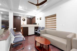 a living room with a couch and chairs and a table at Hill Hara in Tirupati +9 photos