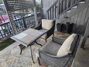 a patio with a table and a bench on a balcony at Sunshine village in Euless