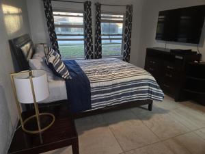 a bedroom with a bed and a television and a dresser at Sunshine village in Euless